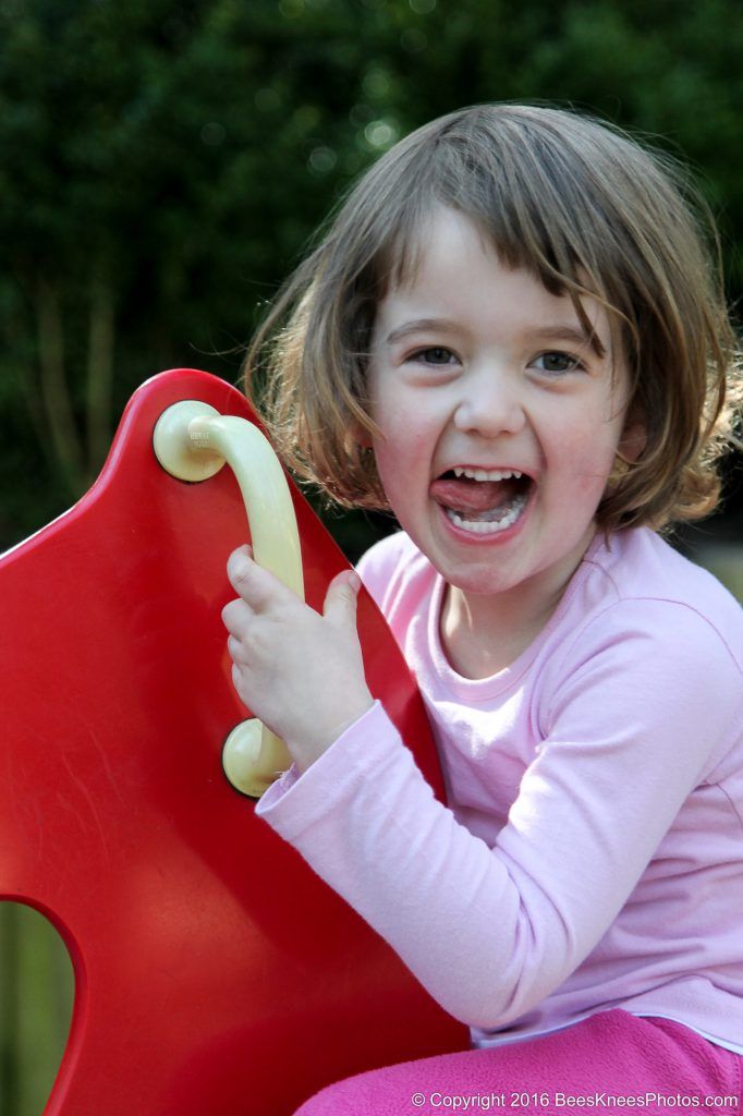 a happy smiling girl playing in the park