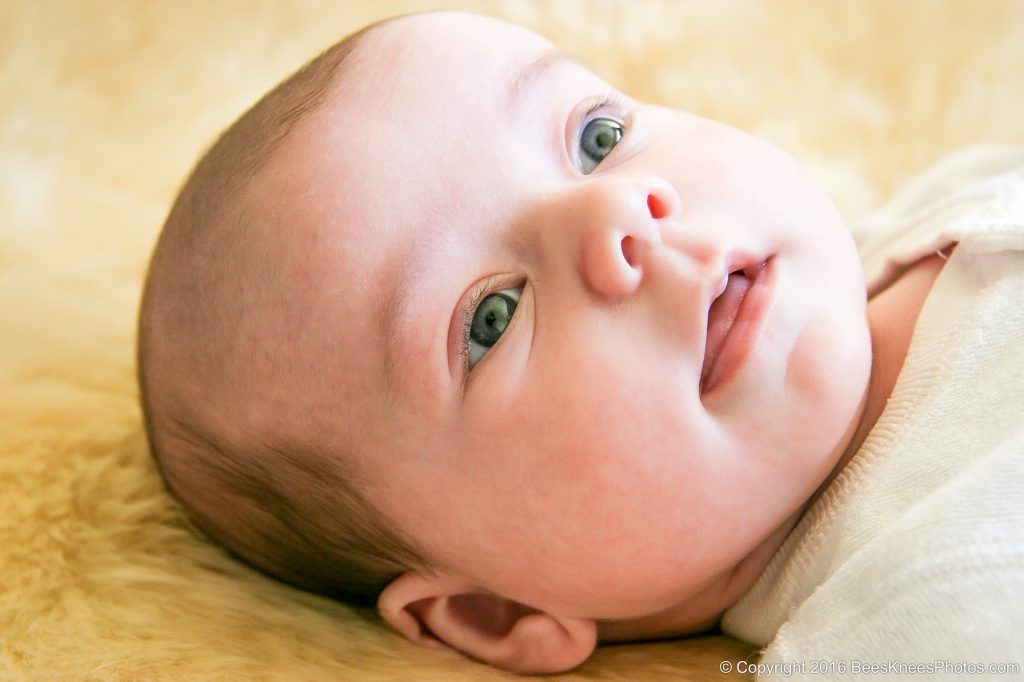 baby lying on a sheepskin