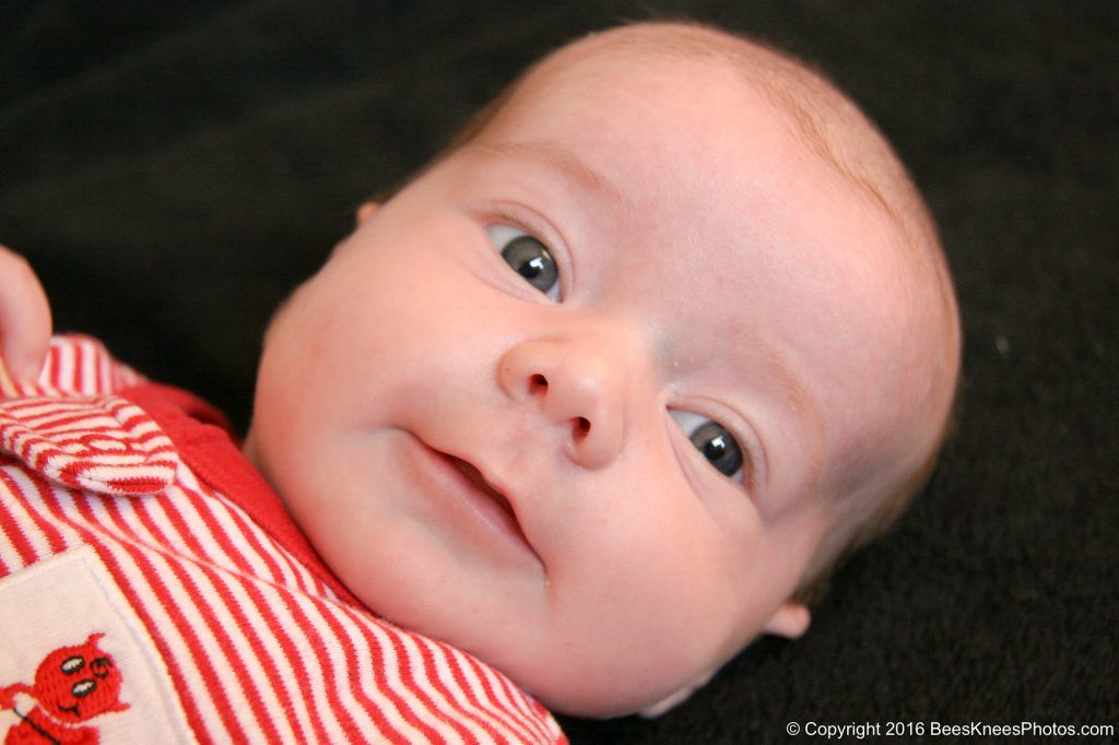 baby wearing red and white stripes