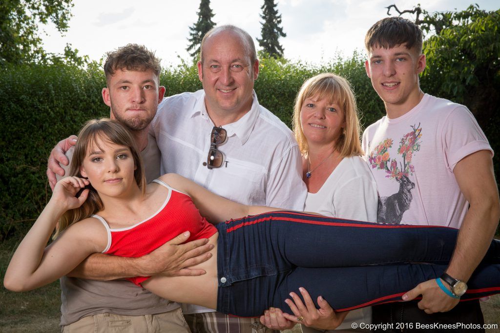 brothers carrying their teenage sister