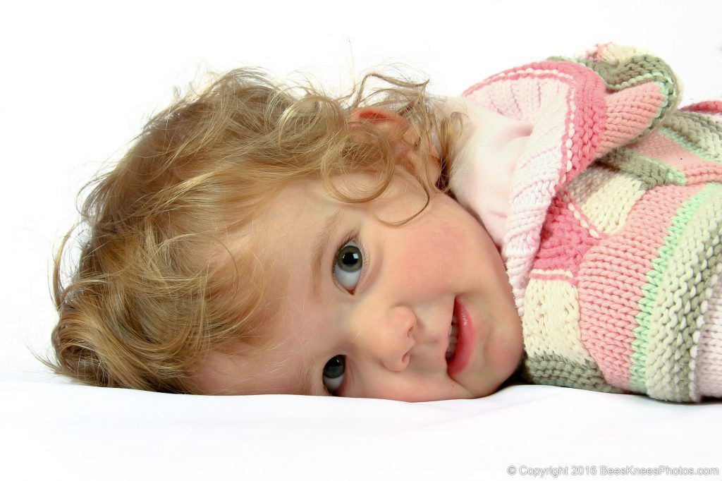 girl lying down in the studio at a family photoshoot