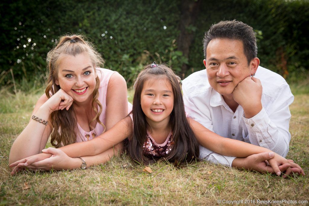 mum dad and daughter holding hands