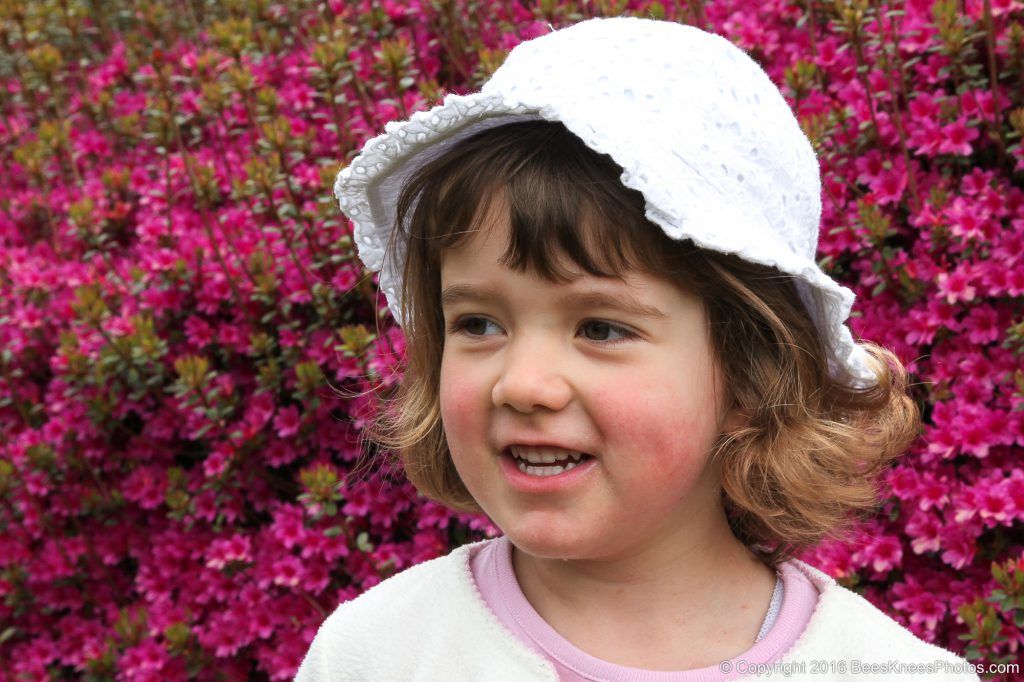 natural photo of a young girl in a pretty garden