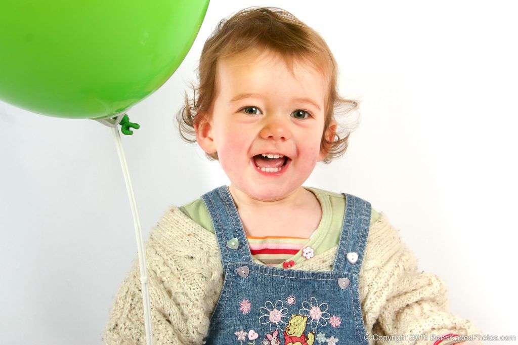 studio photoshoot of a girl with a balloon