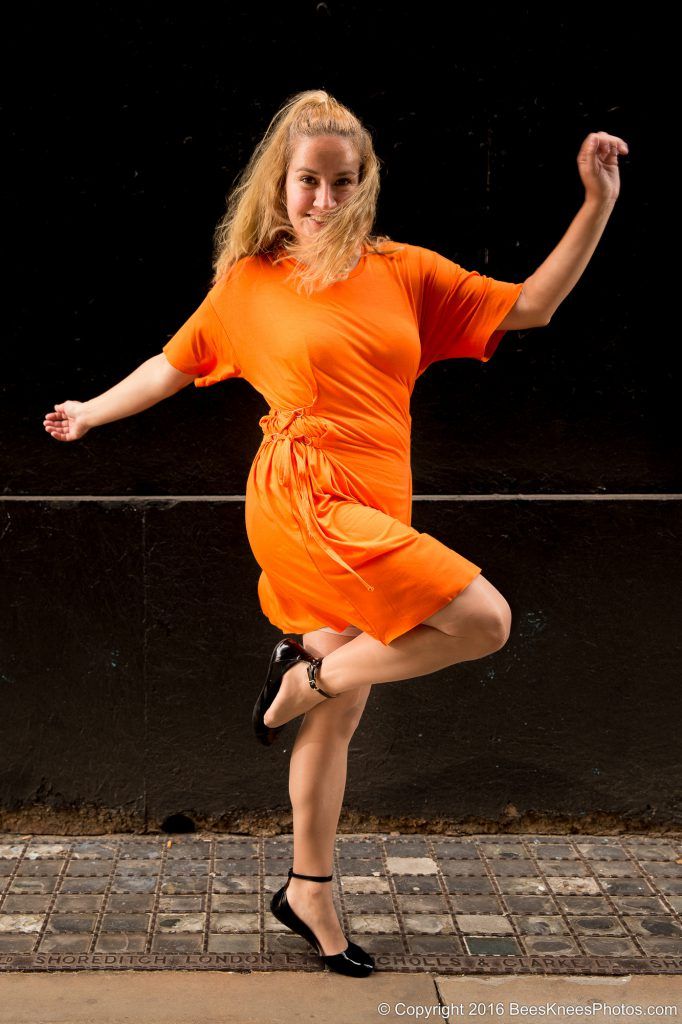 woman dancing in an orange dress