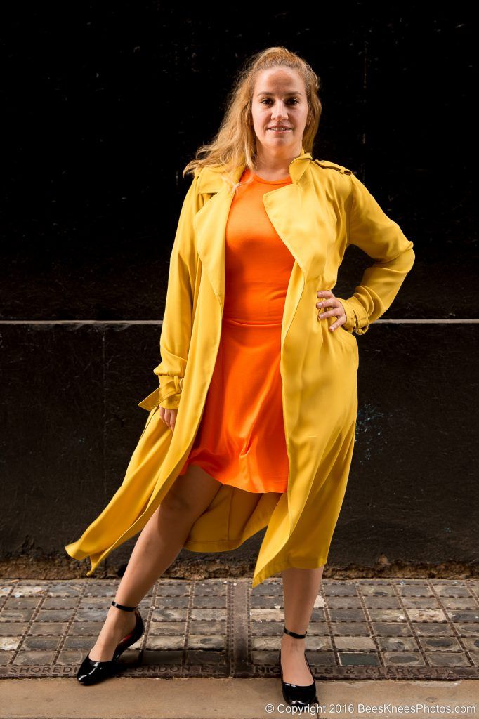 woman in an orange dress and yellow coat