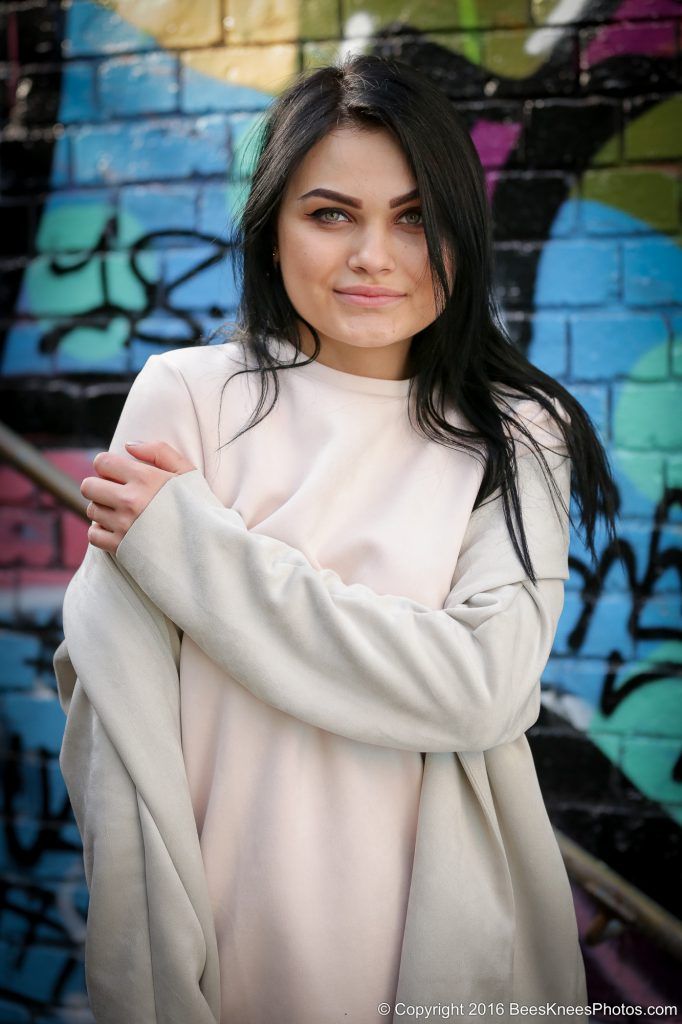 woman standing in front of graffiti