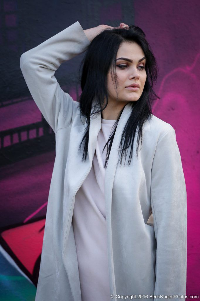 woman stood in front of a purple wall