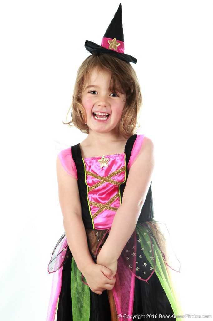 young girl dressed in a witch's costume at halloween