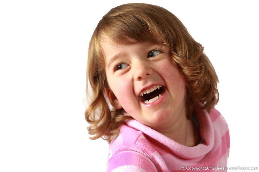 young girl enjoying a studio family photoshoot