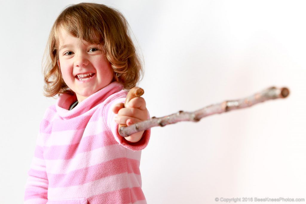 young girl having fun at a family photoshoot in the studio