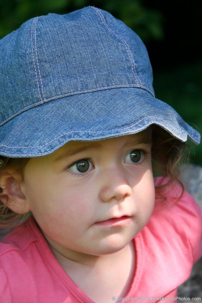 young girl in a blue hat