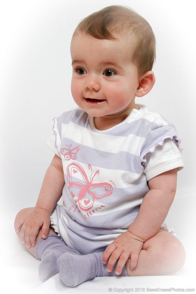 young girl wearing a striped white and mauve