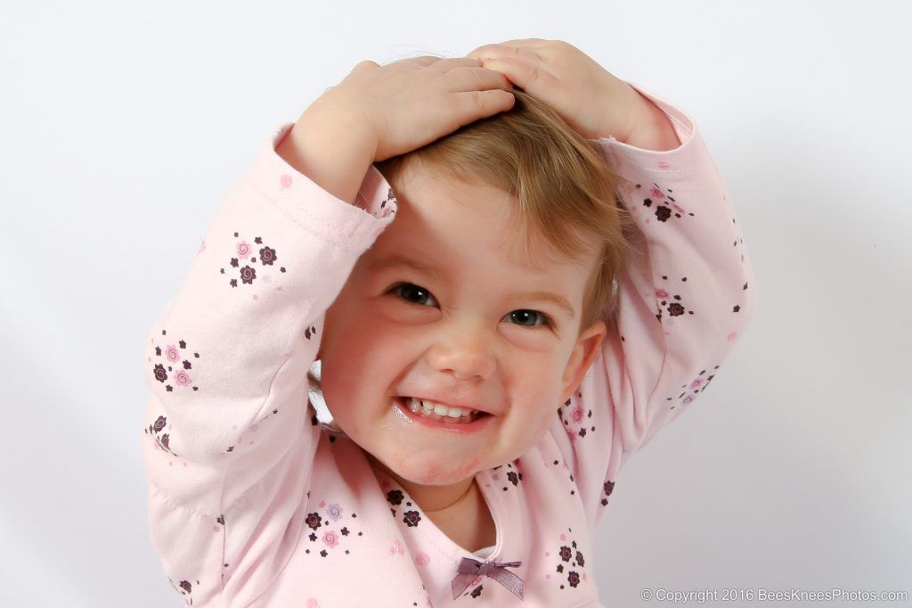 young girl with her hands on her head during a family photoshoot